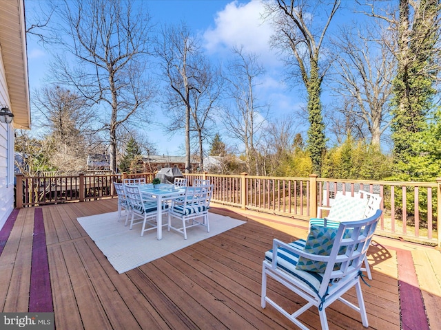 wooden terrace with outdoor dining area