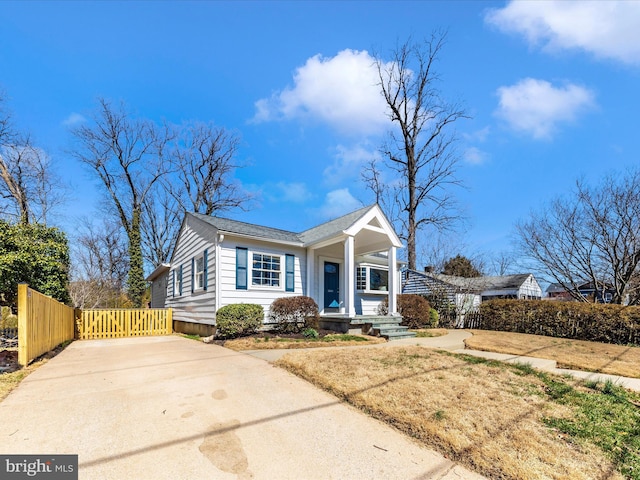 view of front of property with a porch and fence