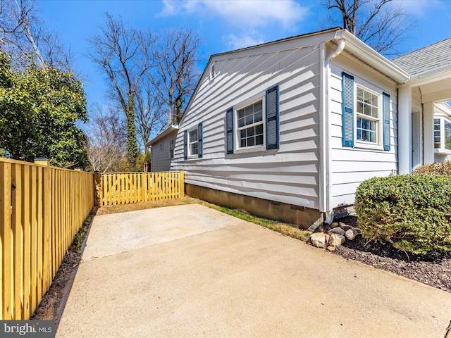 view of home's exterior featuring a patio and fence