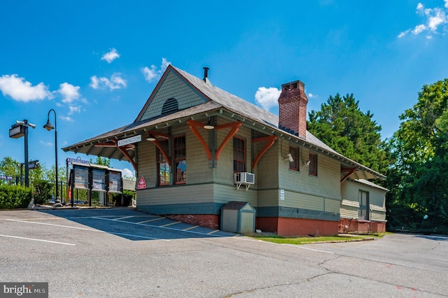 view of property with cooling unit and uncovered parking