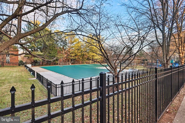 view of pool with a yard and fence