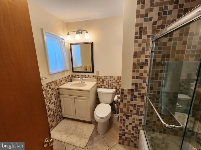 bathroom with a stall shower, tile patterned flooring, tile walls, and toilet