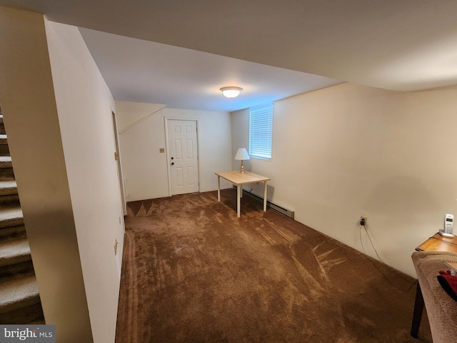 basement with a baseboard heating unit, stairway, and carpet flooring