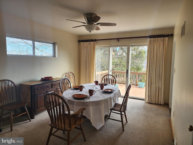 dining area featuring light carpet and ceiling fan