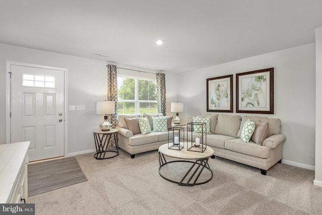 living room with recessed lighting, visible vents, and baseboards