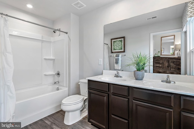 full bathroom with toilet, a sink, and visible vents