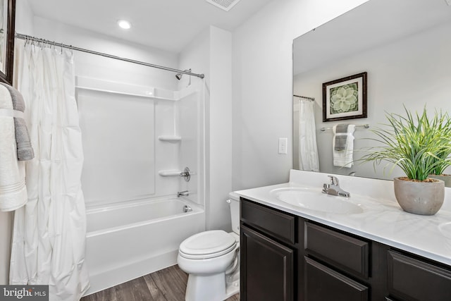 bathroom with visible vents, toilet, wood finished floors, shower / bathtub combination with curtain, and vanity