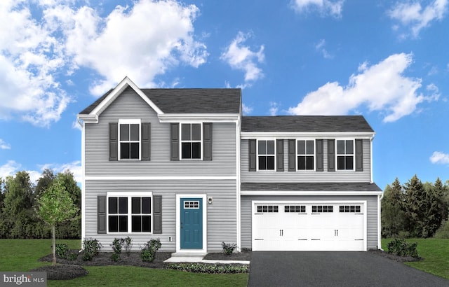 traditional home featuring a garage, driveway, and a front lawn