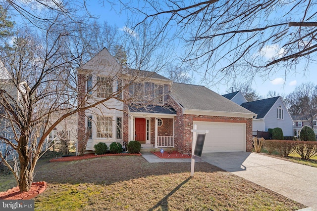 traditional-style house with brick siding, concrete driveway, a front yard, a balcony, and an attached garage