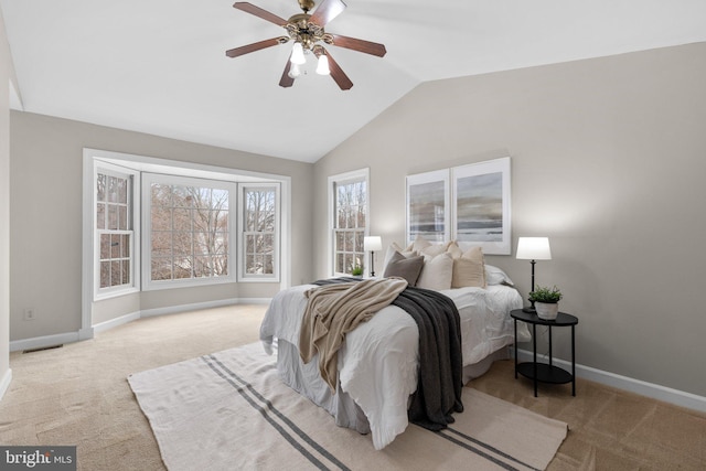 carpeted bedroom with visible vents, baseboards, lofted ceiling, and a ceiling fan