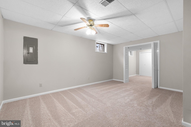 spare room with visible vents, light carpet, electric panel, a paneled ceiling, and baseboards