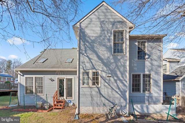 rear view of house featuring entry steps