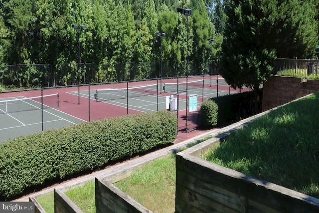 view of sport court featuring fence