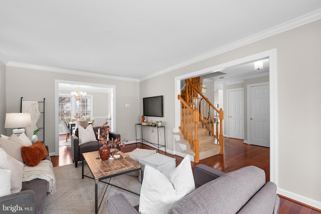 living area featuring ornamental molding, wood finished floors, an inviting chandelier, baseboards, and stairs