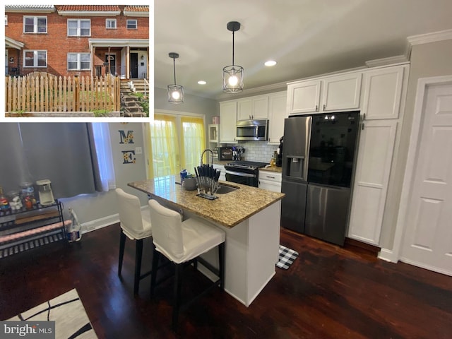 kitchen featuring dark wood-style floors, tasteful backsplash, appliances with stainless steel finishes, white cabinetry, and light stone countertops