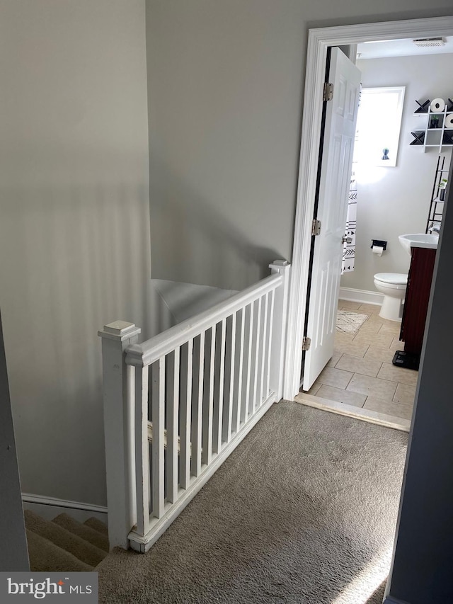 hallway featuring carpet and visible vents