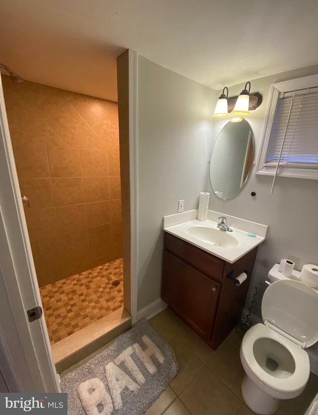 full bathroom with a stall shower, tile patterned flooring, vanity, and toilet