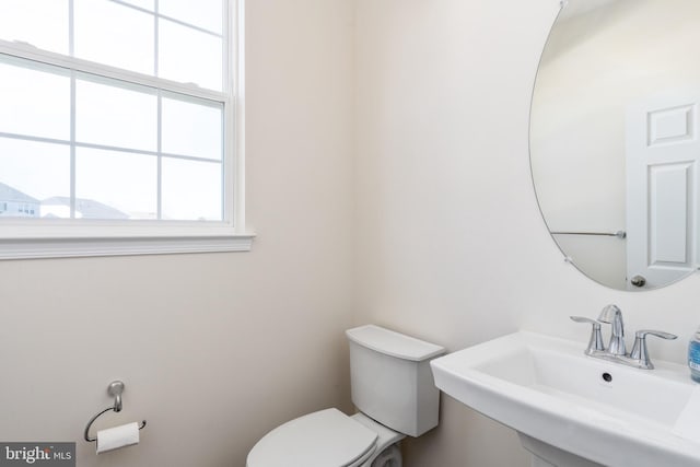 half bath with a sink and toilet