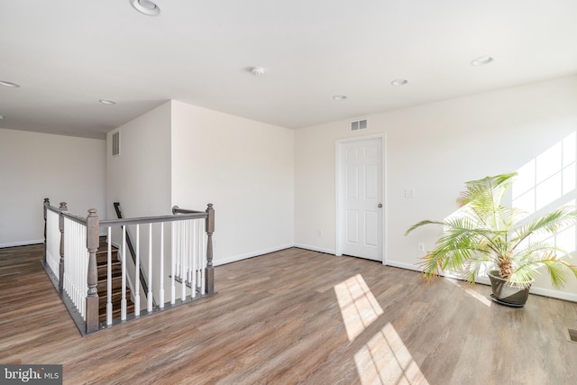 unfurnished room featuring visible vents and wood finished floors