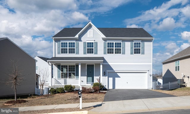 view of front facade with a porch, driveway, and an attached garage