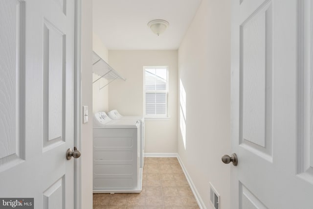 laundry area with light tile patterned floors, visible vents, laundry area, independent washer and dryer, and baseboards