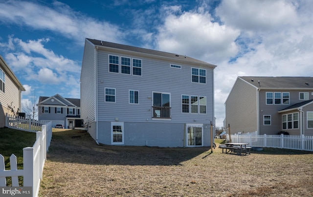 back of property with a fenced backyard and a yard