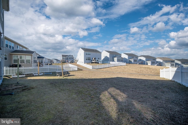 view of yard featuring a fenced backyard and a residential view