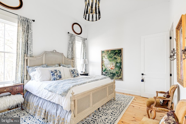 bedroom with baseboards and wood finished floors