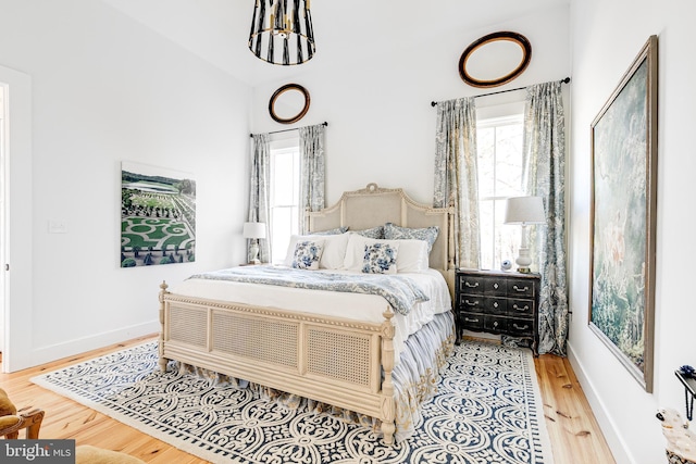 bedroom featuring wood finished floors and baseboards