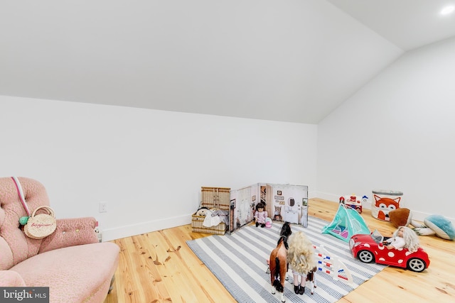 game room with lofted ceiling, baseboards, and wood finished floors