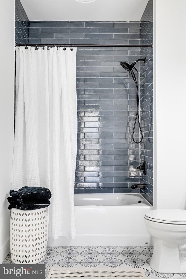 full bath featuring tile patterned flooring, shower / bath combination with curtain, and toilet