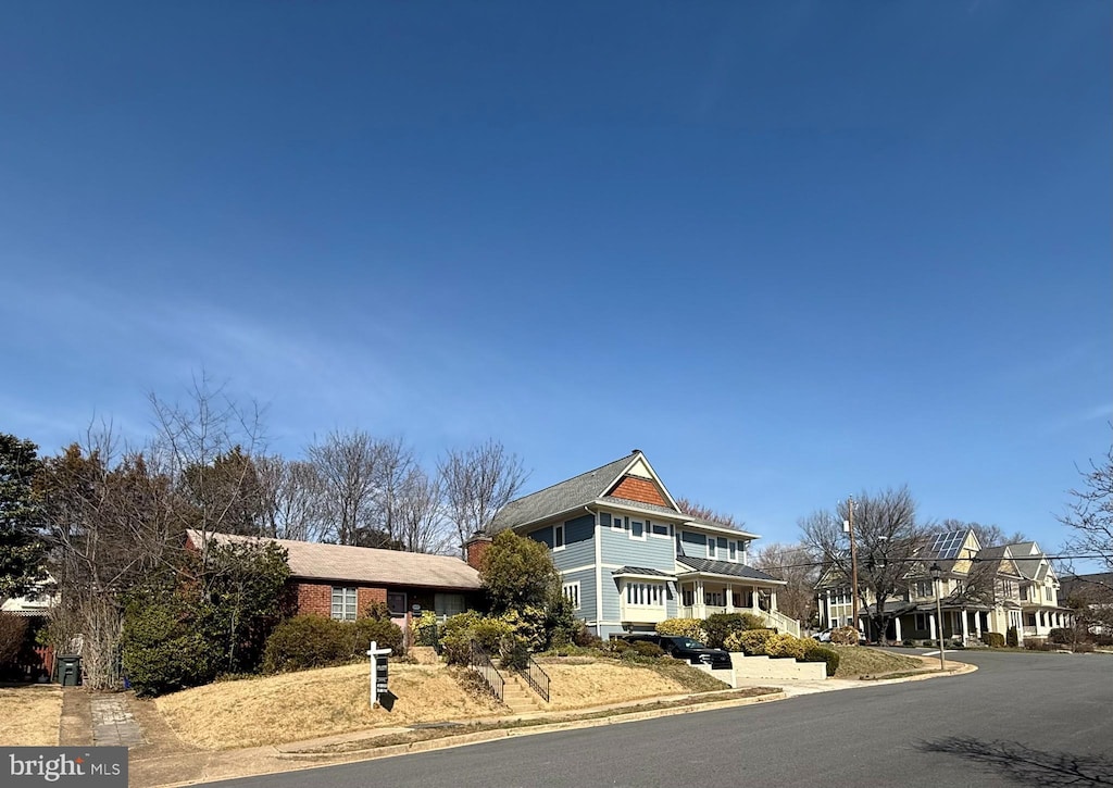 shingle-style home featuring a chimney