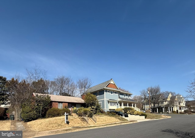 shingle-style home featuring a chimney