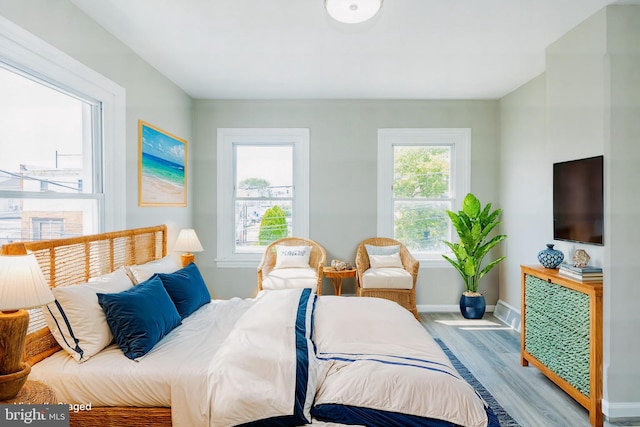 bedroom featuring baseboards and wood finished floors