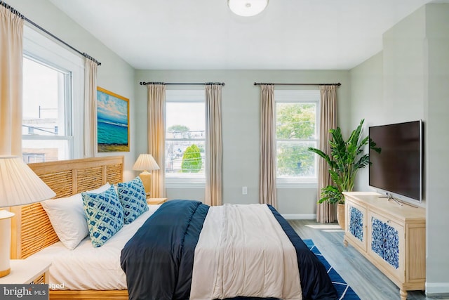 bedroom with wood finished floors and baseboards