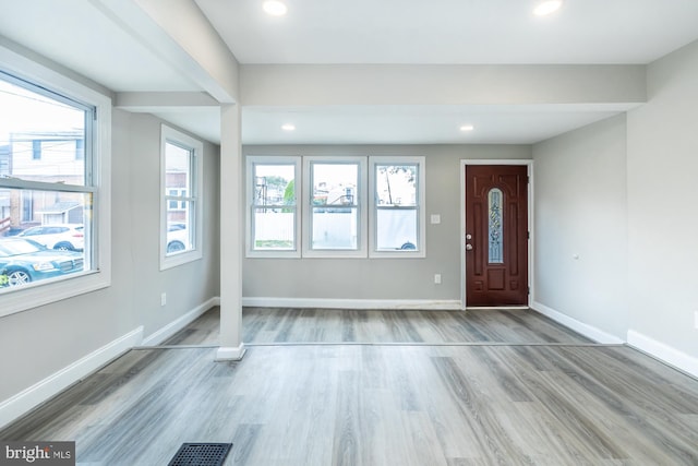 entryway with recessed lighting, wood finished floors, visible vents, and baseboards