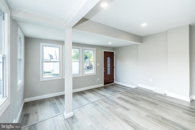 foyer entrance with visible vents, baseboards, wood finished floors, and recessed lighting