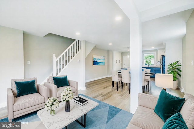 living area featuring recessed lighting, stairway, baseboards, and wood finished floors