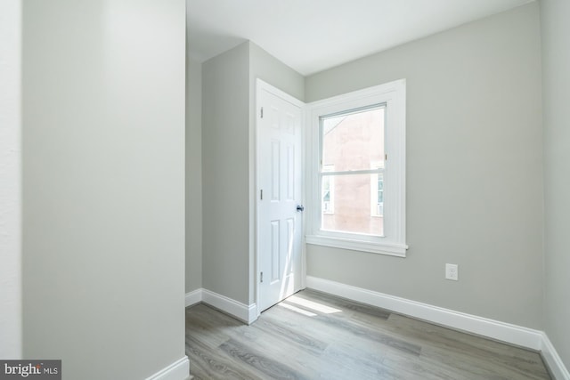 interior space with baseboards and wood finished floors