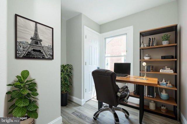 office area with baseboards and wood finished floors