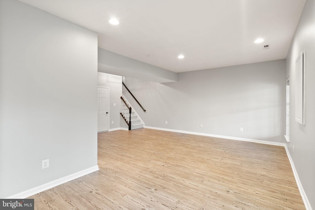 spare room with recessed lighting, stairway, baseboards, and wood finished floors