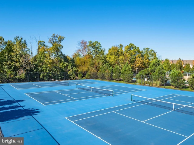 view of sport court featuring fence