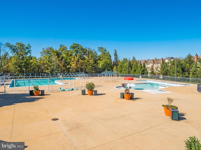 pool featuring fence and a patio