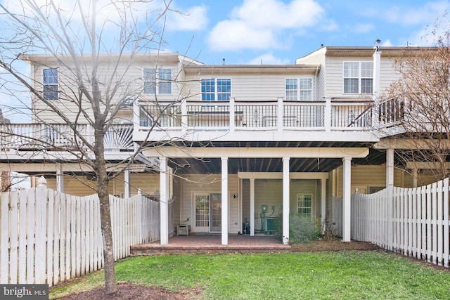 rear view of property with a patio area, a fenced backyard, and a lawn