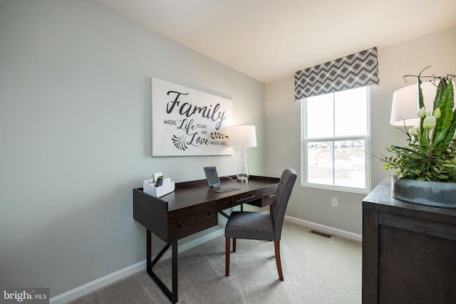 office area with visible vents, light carpet, and baseboards