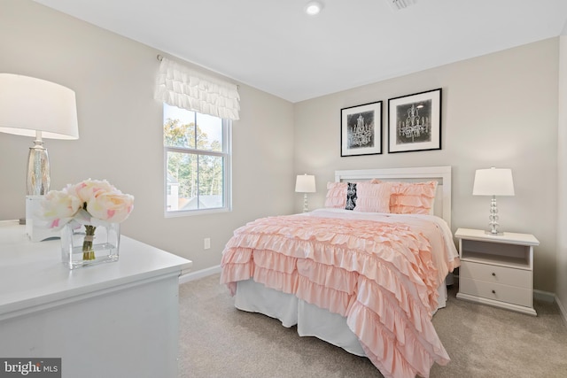 bedroom featuring light carpet and baseboards