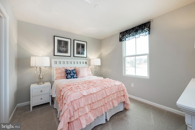 carpeted bedroom featuring baseboards