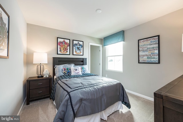 carpeted bedroom featuring baseboards