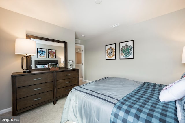 bedroom with light carpet and baseboards