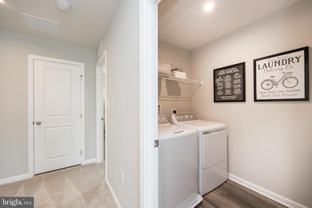 washroom featuring laundry area, carpet, washing machine and dryer, and baseboards